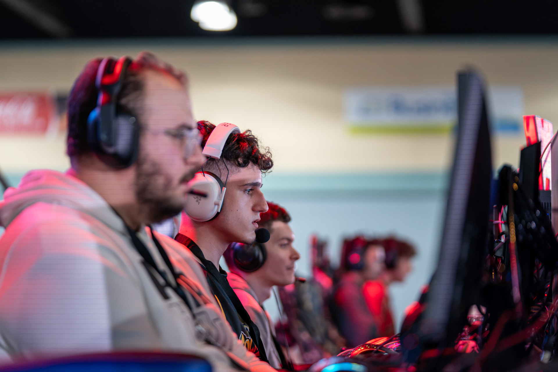 Competitors wearing headsets during a live gaming event