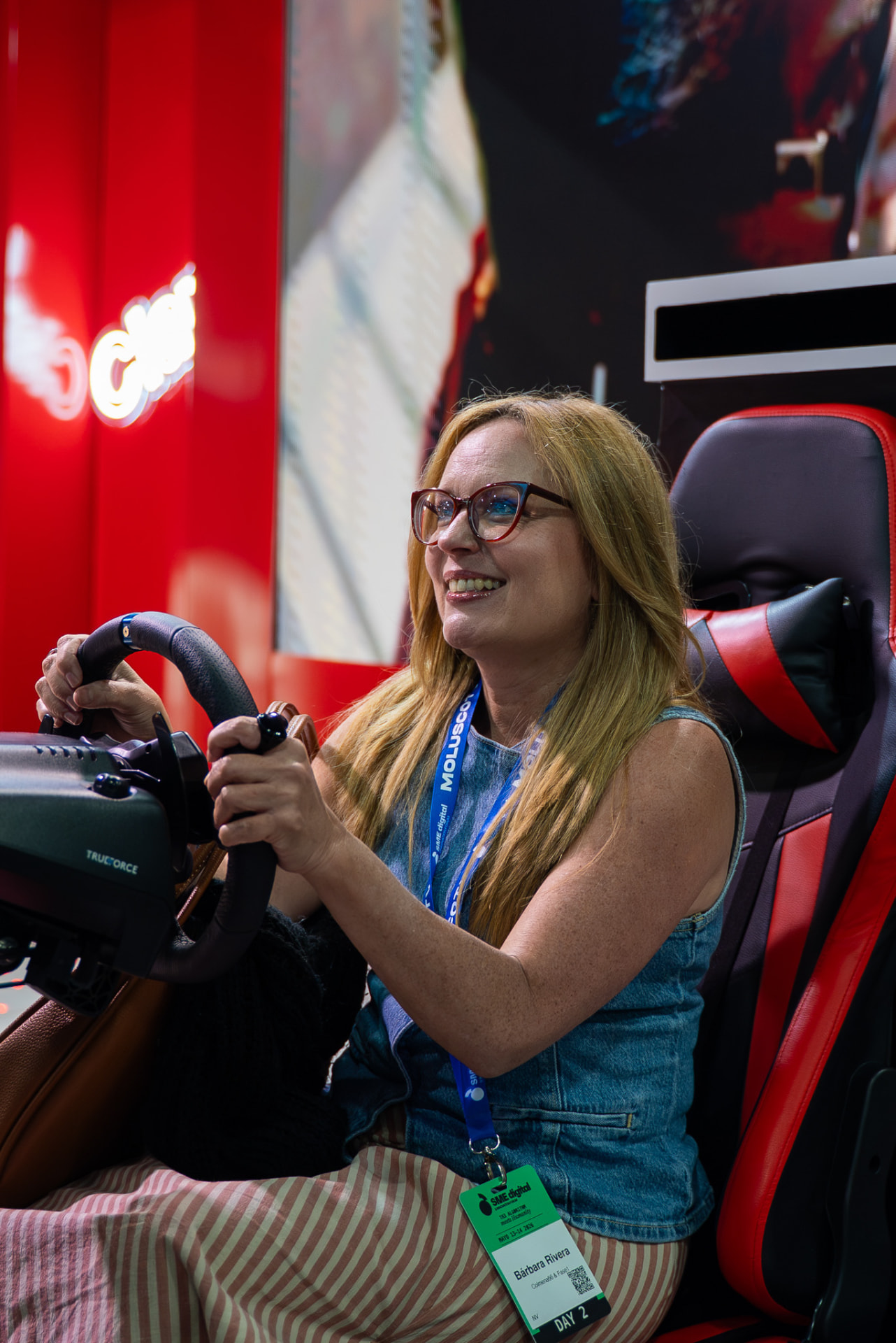 Attendee enjoying a driving simulator at an expo