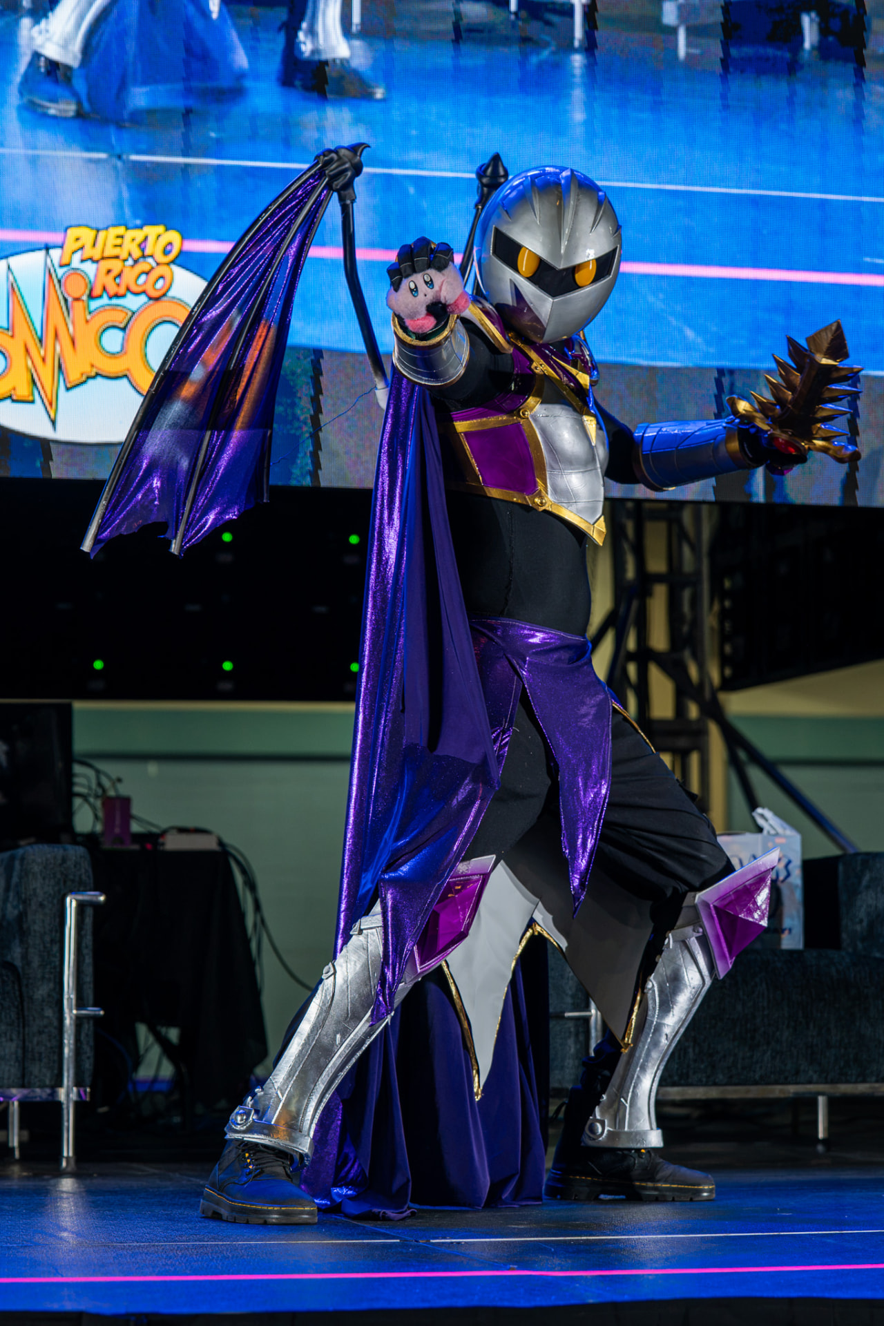 Armored cosplayer performing on a convention stage