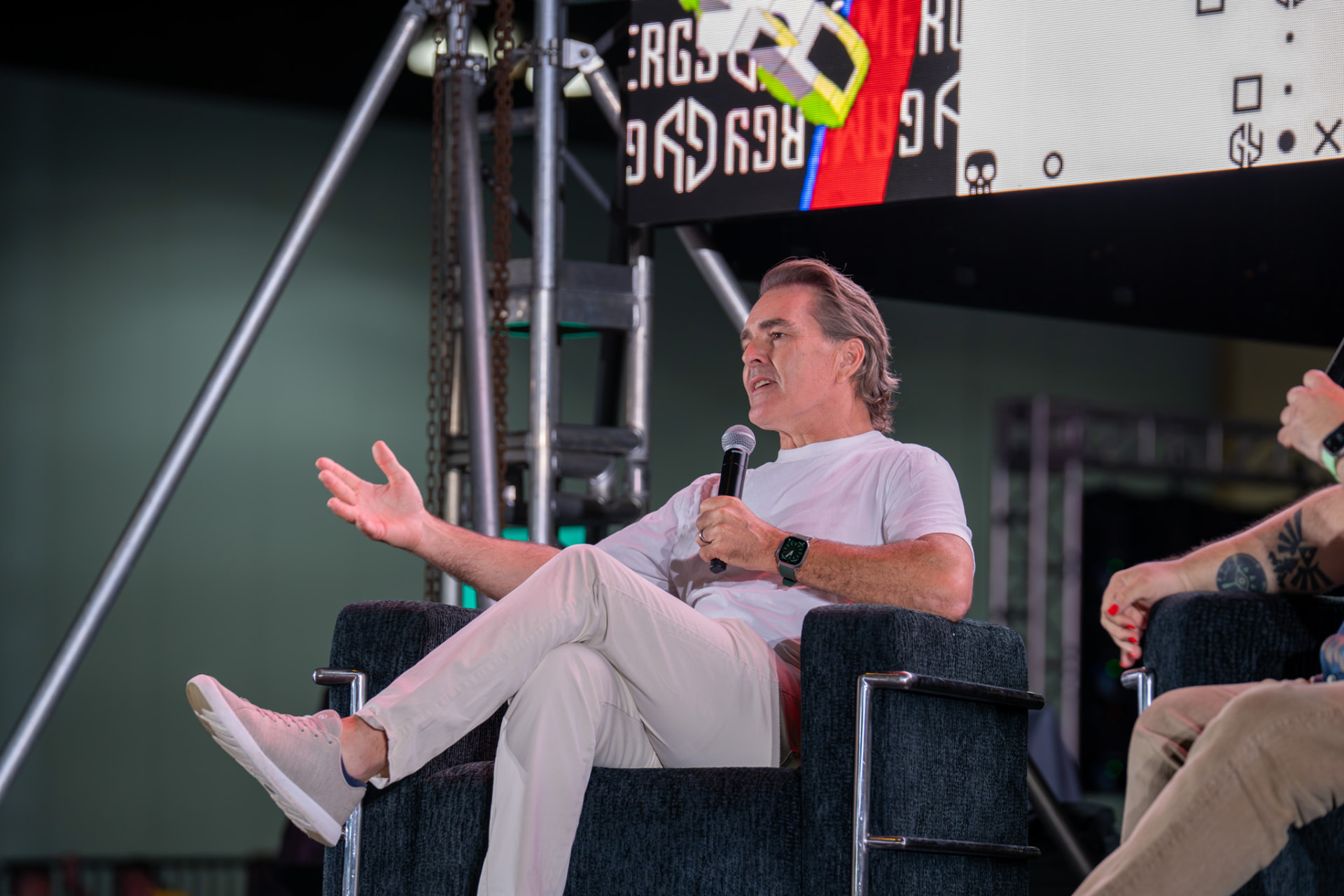 Featured panelist speaking to the audience at a convention