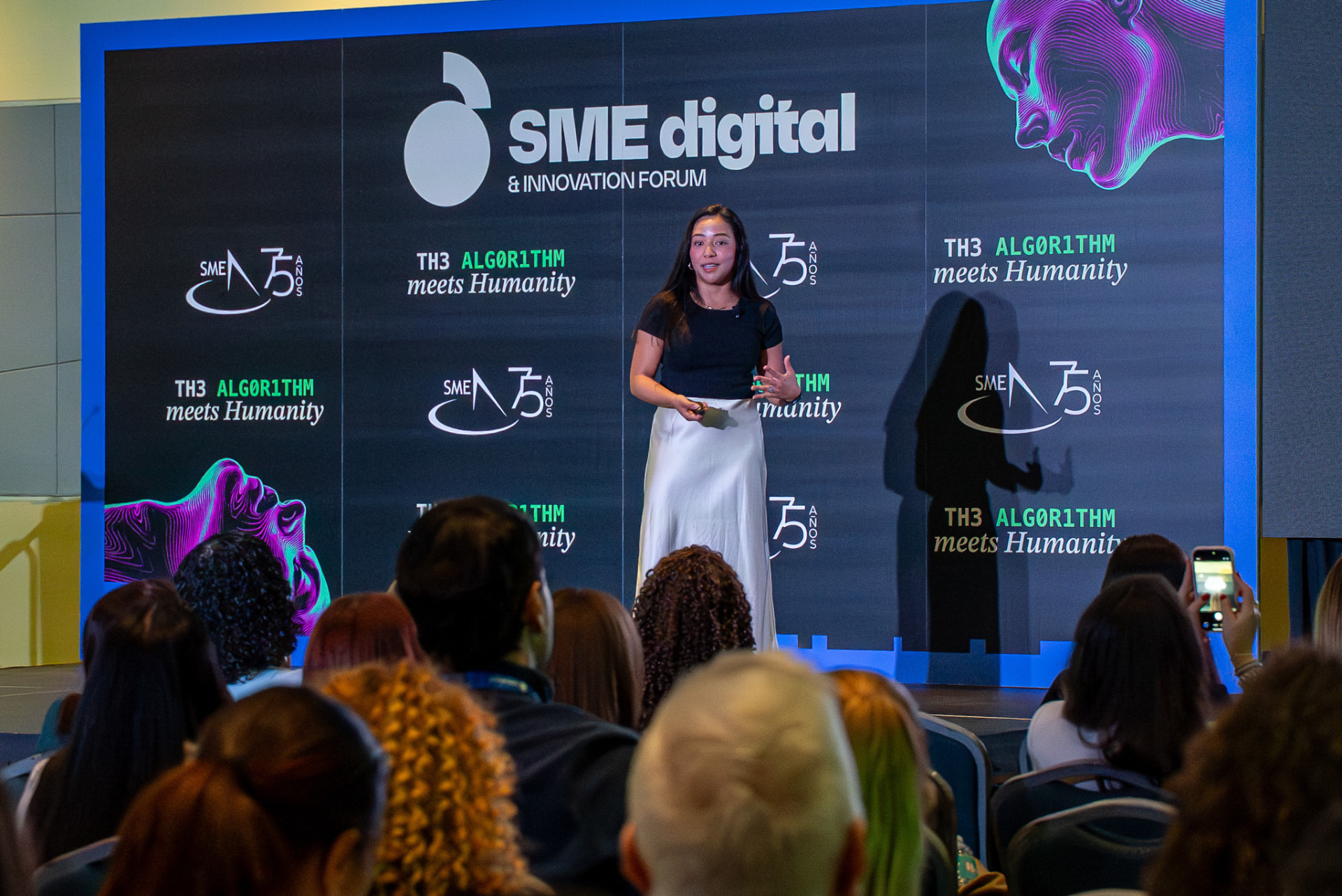 Speaker presenting to an audience at a digital forum