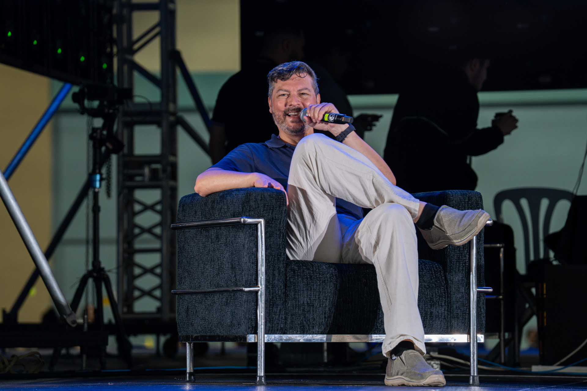 Guest speaker seated on stage during a convention panel