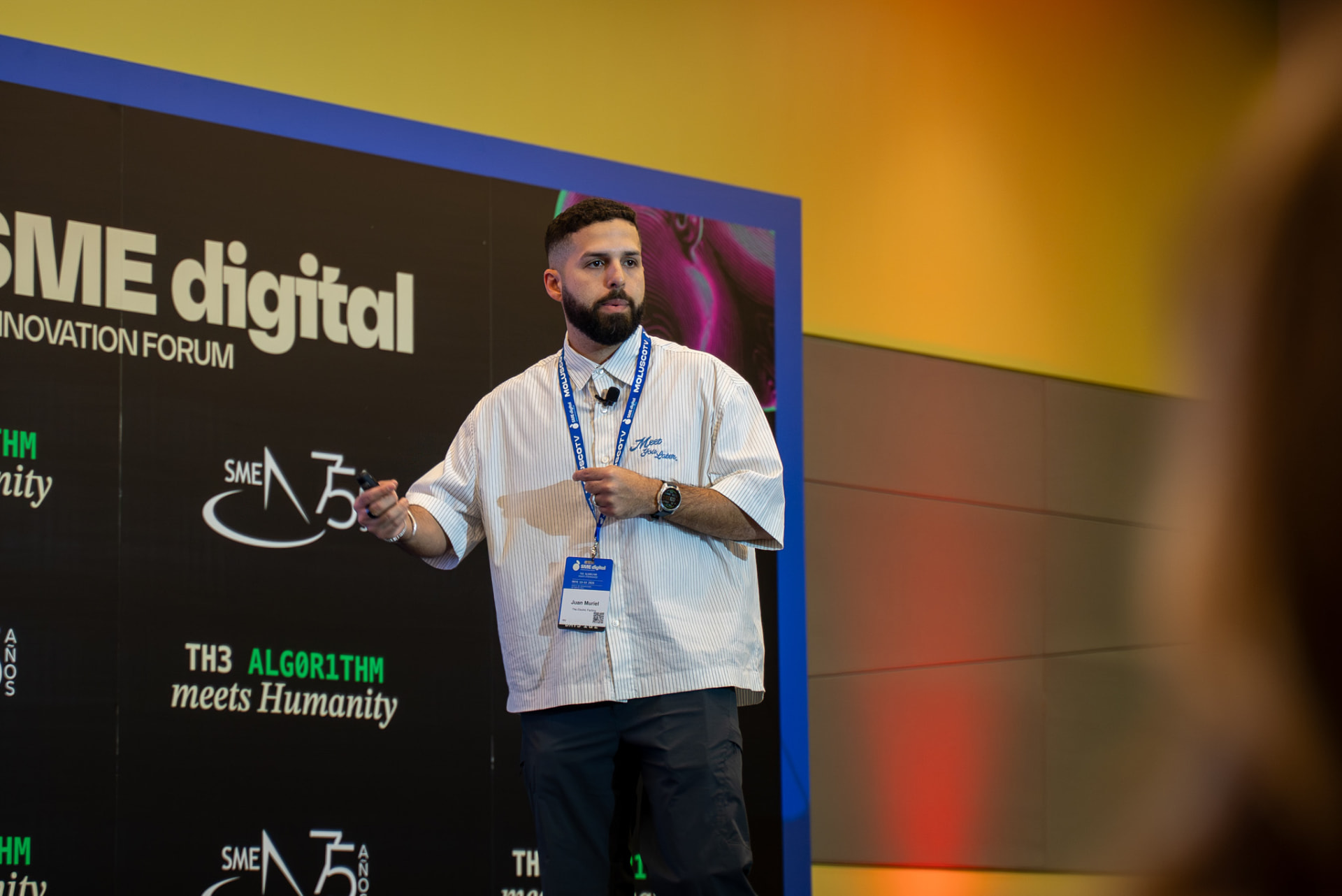 Presenter speaking on stage at a digital innovation forum