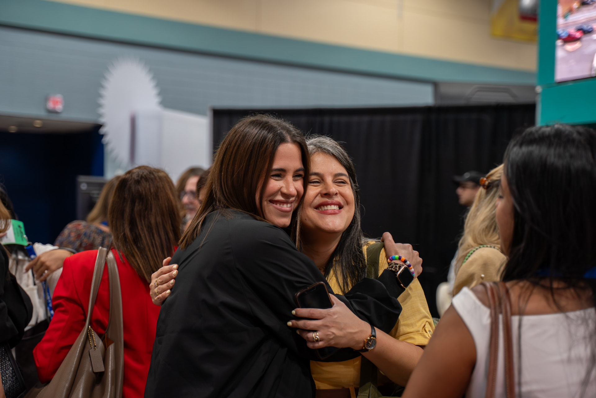 Two attendees greeting each other at a business event