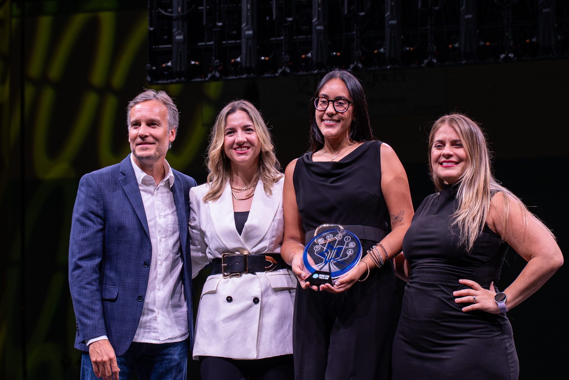 Award recipient posing with event organizers